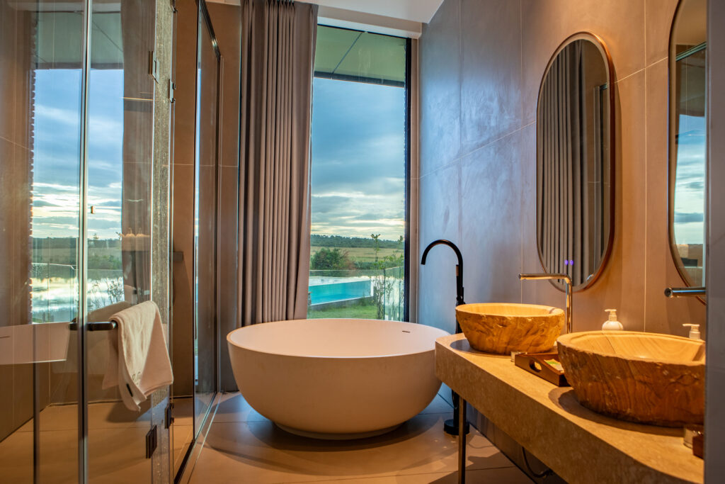 Freestanding bathtub with a view over the bush at a safari lodge